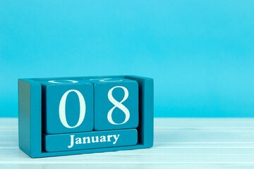 wooden calendar with the date of December 8 on a blue wooden background