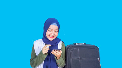 asian hijab woman traveler with suitcase on color background