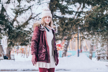 Portrait of the happy girl in the winter park