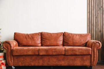Orange leather sofa with with white wall in background