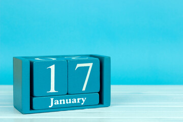 wooden calendar with the date of December 17 on a blue wooden background, World Snow Day;...
