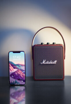 Marshall Stockwell II Bluetooth speaker with iPhone11 Black is standing on the desk, blurry background and object. 06.12.2020 Bornova_Izmir_Turkey