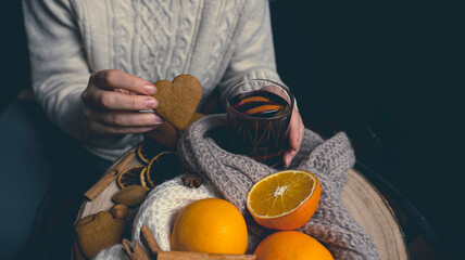 warm drinks in cold weather, a girl with a glass of gluntwine and heart-shaped cookies, on the...