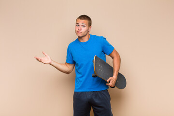 young blonde man feeling puzzled and confused, doubting, weighting or choosing different options...