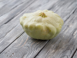 Pattypan squash on old rustic wooden background.