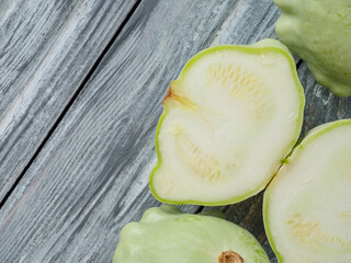 Pattypan squash on old rustic wooden background.