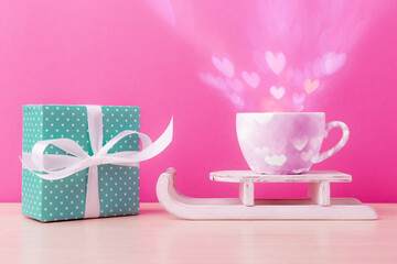 Blue gift box and cup with Valentine's hearts on Santa’s sleight