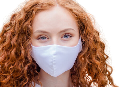 Woman wearing protective face mask, posing on white background. Close up studio portrait.  isolated, empty copy space for text