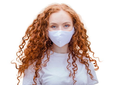 Woman wearing protective face mask, posing on white background. Close up studio portrait.  isolated, empty copy space for text