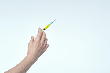 close up of a hand showing syringe with vaccine