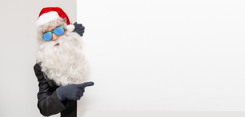 Santa Claus indicating something a white poster