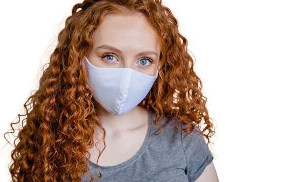 Woman wearing protective face mask, posing on white background. Close up studio portrait.  isolated, empty copy space for text