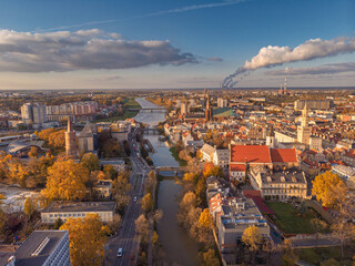 A drone view of the historic city with the market square, churches, town hall and the castle tower in Opole during sunset. Autumn in Silesia - Poland.