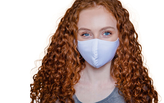 Woman wearing protective face mask, posing on white background. Close up studio portrait.  isolated, empty copy space for text