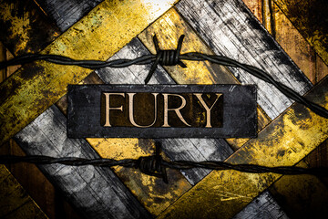 Fury text with barbed wire on grunge silver with textured gold background