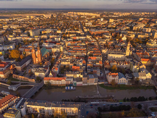 A drone view of the historic city with the market square, churches, town hall and the castle tower in Opole during sunset. Autumn in Silesia - Poland.