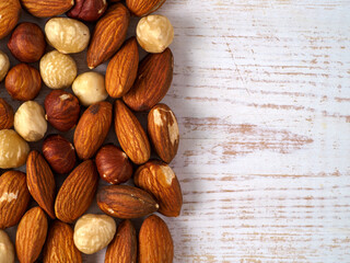 Mix of nuts on wooden background.
