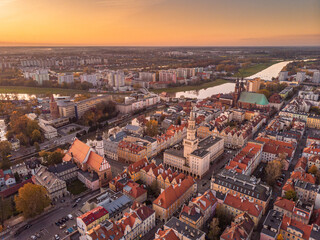 Obraz premium A drone view of the historic city with the market square, churches and the town hall in Opole during sunset. Autumn in Silesia - Poland.