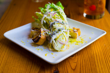 Salad. Classic American or French restaurant salad made with kale, Arugula, almonds, blueberries, walnuts, tomatoes, bacon, blue cheese, avocado, tossed with olive oil.