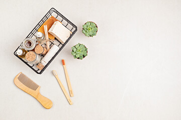 Eco friendly soap bar, tooth brushes, cotton swabs, bath salt, clay mask and washcloth on neutral background. Zero waste sustainable lifestyle. Organic Self care concept