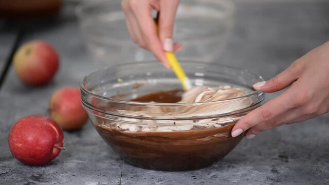 Woman hands stir delicious chocolate mousse for cake.