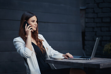 Business woman at work with laptop in cafe