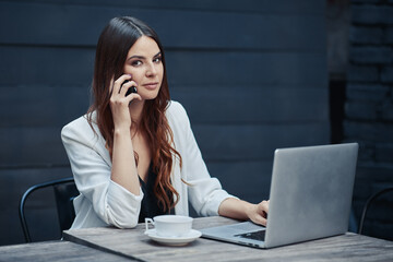 Business woman at work with laptop in cafe