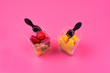 fruit platter in transparent cups with black forks