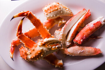 King crab or Dungeness legs . Jumbo Crab served with lemons, spicy rémoulade sauce on top of a mixed green salad. Classic American restaurant or steakhouse appetizer or entree.