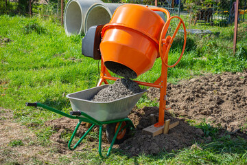 ready-mixed concrete discharged into a cart from a 200 liter electric concrete mixer