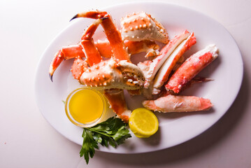 King crab or Dungeness legs . Jumbo Crab served with lemons, spicy rémoulade sauce on top of a mixed green salad. Classic American restaurant or steakhouse appetizer or entree.