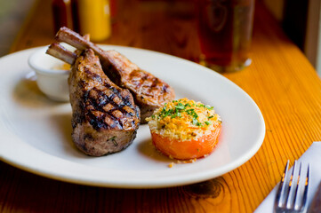 Lamb Chops. Grass-fed lamb, grilled to a medium rare and served with a garlic herb butter sauce and paired with roasted potatoes and Brussels sprouts. Classic American steakhouse favorite. 