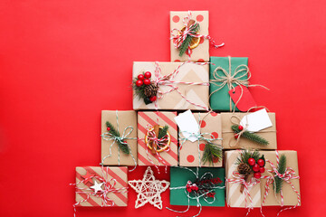Gift boxes with ornaments on red background