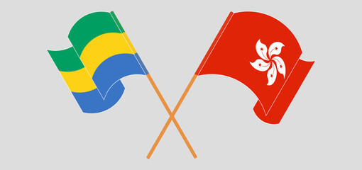 Crossed and waving flags of Gabon and Hong Kong