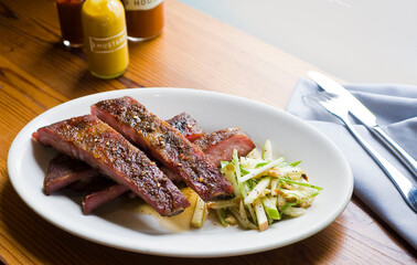Pork ribs, barbecue style. Classic Traditional Texas Smokehouse favorite menu item: Baby Back pork ribs. Slow cooked in seasoned smoker over mesquite wood chips covered in homemade bbq sauce. 