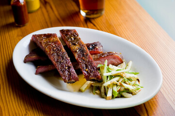 Pork ribs, barbecue style. Classic Traditional Texas Smokehouse favorite menu item: Baby Back pork ribs. Slow cooked in seasoned smoker over mesquite wood chips covered in homemade bbq sauce. 