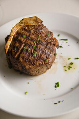 Steaks. Grade A grass fed angus beef steaks. Tenderloin, filet mignon, New York strip, bone in rib-eye grilled medium rare on outdoor wood-fired grill. Classic American steakhouse entree favorite.