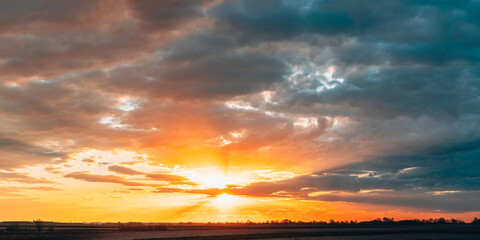 Sun Shine During Sunset Above Empty Spring Countryside Rural Soil Landscape. Field Under Sunny Spring Sky. Agricultural Landscape With Copy Space. Panorama