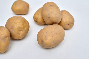 fresh unpeeled potatoes on a white background