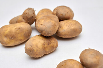 fresh unpeeled potatoes on a white background