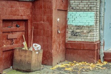 A textured fragment of a corner of a house with a courtyard that has been left without major repairs for a long time