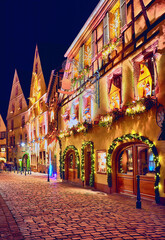 Fototapeta na wymiar cozy street of Kaysersberg old village on Christmas holidays. Alsace, France