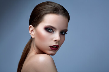 Face of a beautiful girl with smoky eyes makeup.