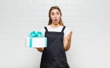 blonde pretty woman open-mouthed and amazed, shocked and astonished with an unbelievable surprise