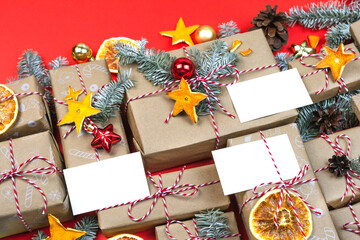 New year gift greeting postcard mockup, many presents, christmas eco decor on red zero waste background