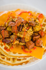 Chicken and waffles. Classic American Diner Style Breakfast or Brunch menu item favorite. Crispy homemade fried chicken on top of home buttermilk waffles topped with butter and maple syrup. 