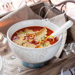 Christmas Tomato Soup with Ornament Shaped Pasta. Winter Decoration.