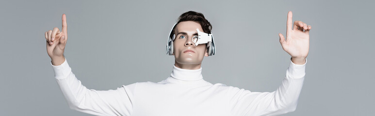 Cyborg in headphones and digital eye lens using something isolated on grey, banner