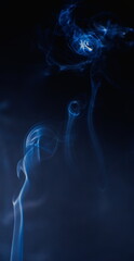 Abstract photographs of billowing smoke swirling and moving in the air.