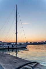 Sailing Boat with Clear Sky on Sunset with Copy Space in Port Water - Vertical Photo